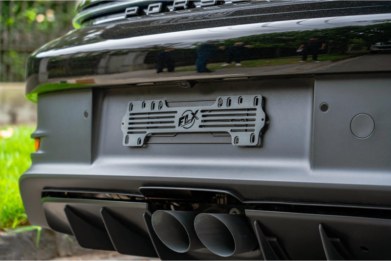 FLX 5 digit heritage number plate bracket mounted on the rear bumper of a car 